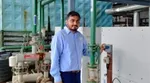 Kothiya Jaydeep from Unilever Hindustan beside a heat pump used to heat water, eliminating the need for diesel