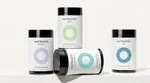 Four jars of Nutrafol products which are designed to help hair health for women and men at various stages in their lives.