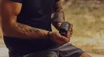 Muscular man taking Onnit’s Shroom Tech Sport supplements, designed to help with cellular energy and cardiovascular endurance.